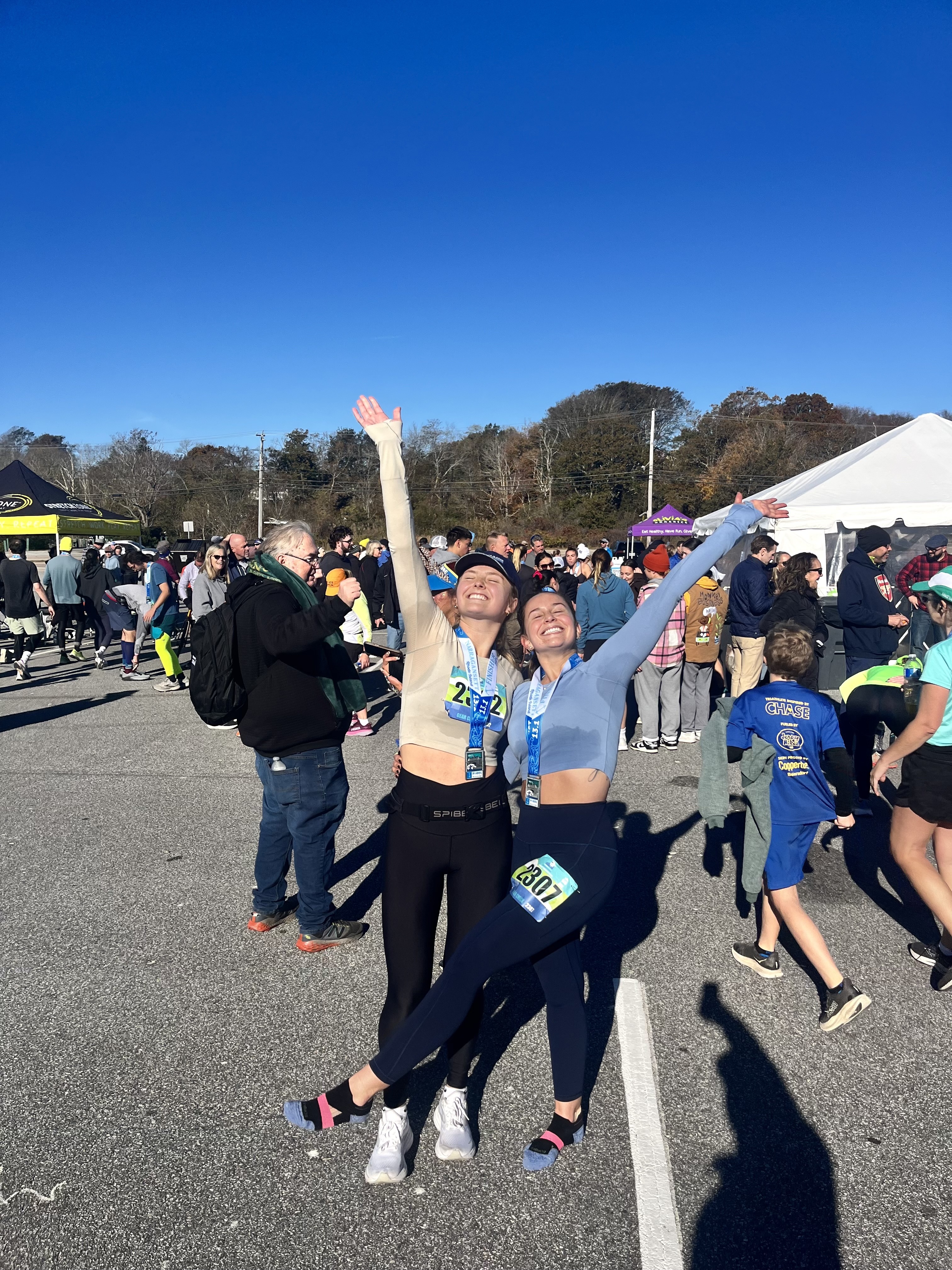 Two women celebrating at a finish line together