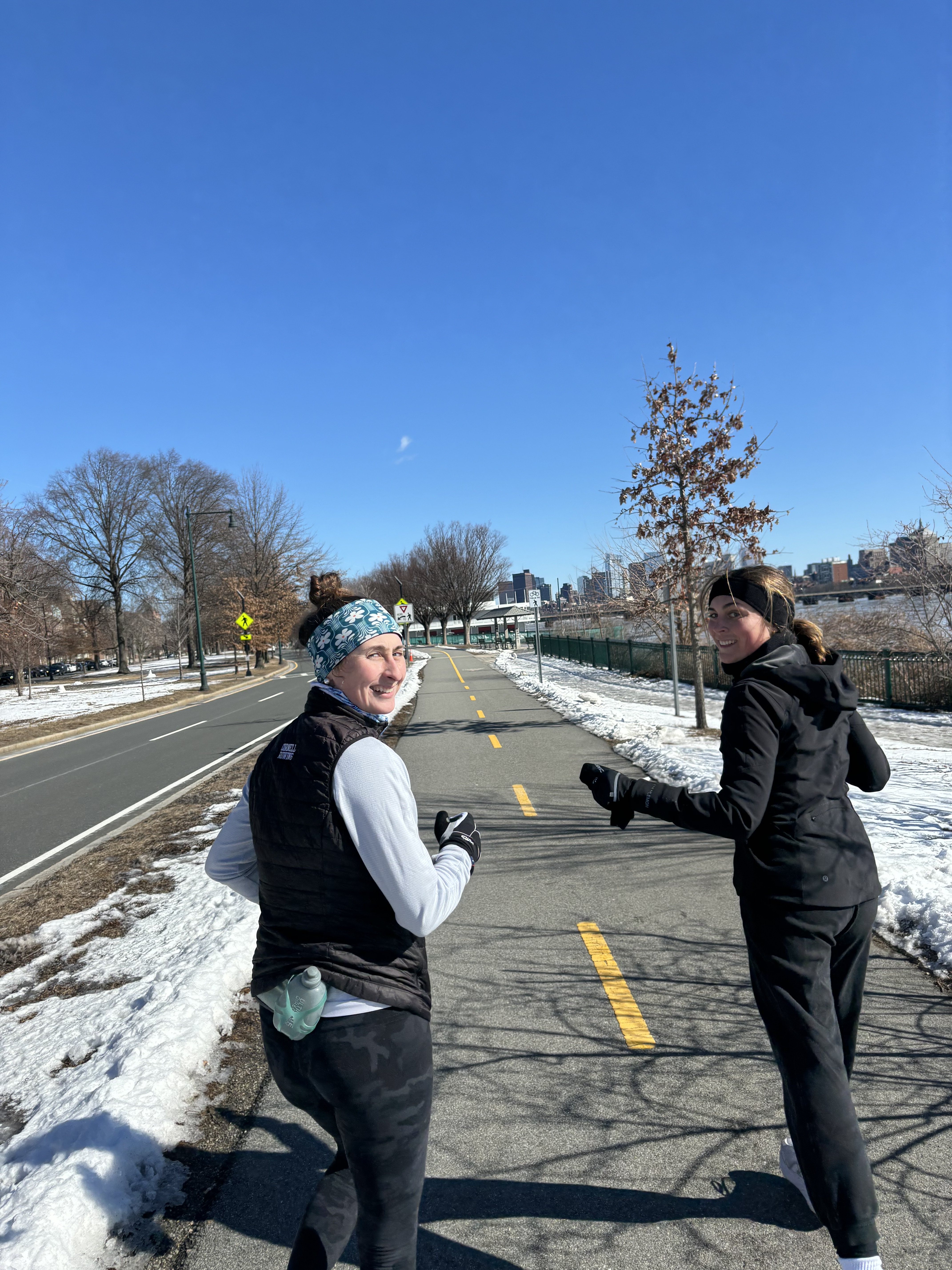 Two women running together in cold weather