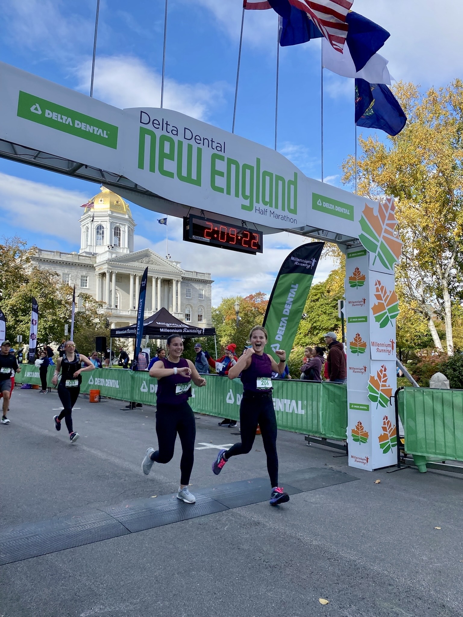 Two women crossing a finish line together